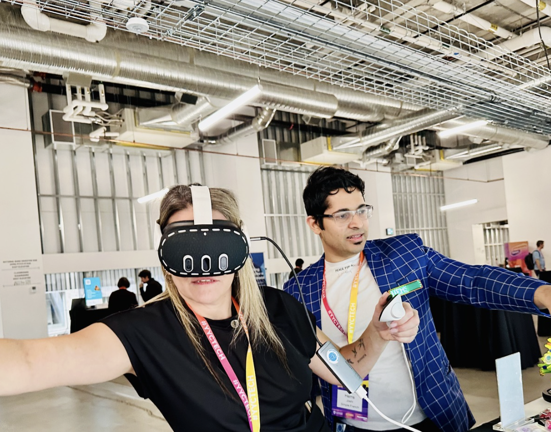 A participant trying Immersive Mind & Memory Program (IMMP) with facilitator support at a public technology event